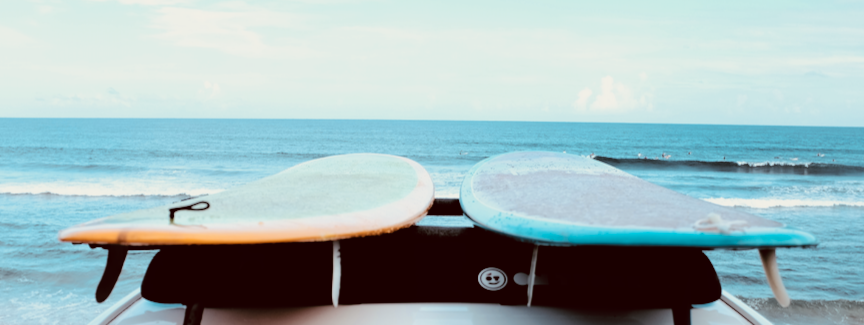 Surfing Portable Shower by OnTrackGear.  Outdoors transition with sand free towels, electric camp shower, camping tent floor. Hobie surfboards.